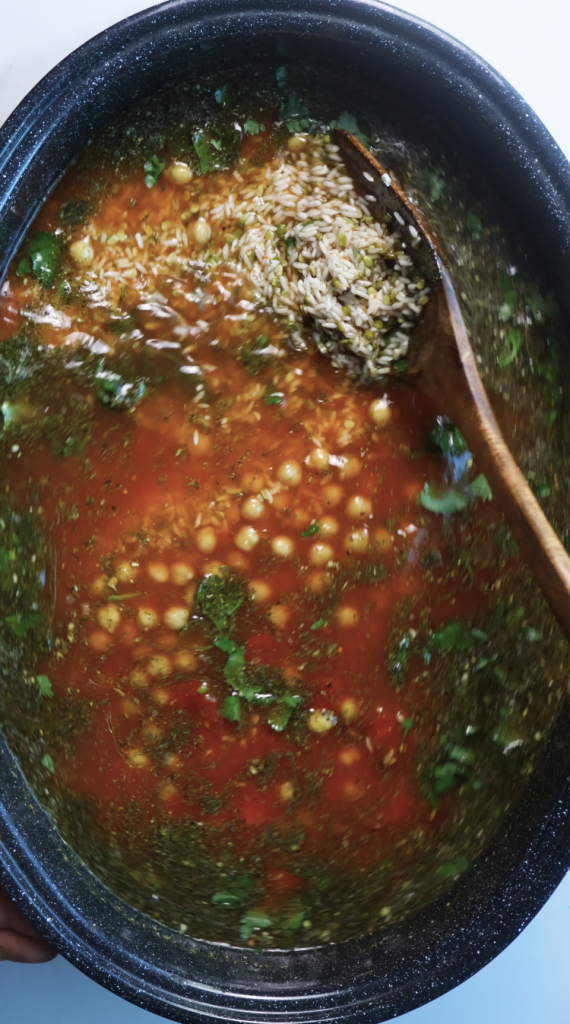 1. Add rinsed rice and mung beans to a large Dutch oven, then add water, beef broth, tomato sauce, oil, chickpeas, seasonings, and cilantro. 